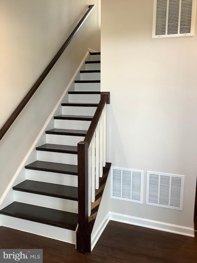 stairs featuring wood-type flooring