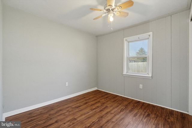 unfurnished room with ceiling fan and dark wood-type flooring