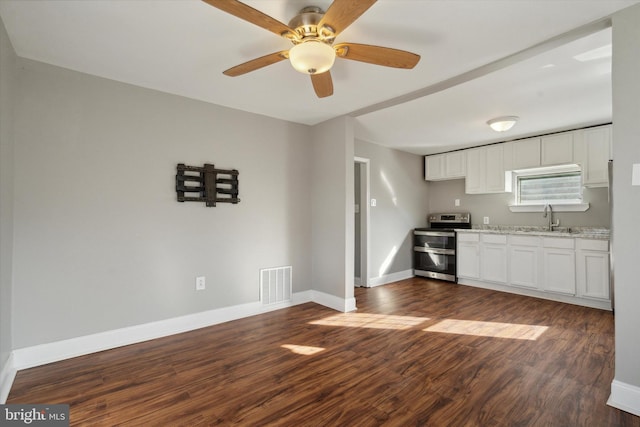 kitchen featuring stainless steel electric stove, dark hardwood / wood-style flooring, sink, and white cabinets