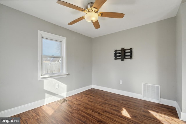 empty room with hardwood / wood-style floors and ceiling fan