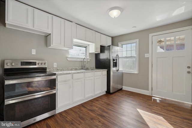 kitchen featuring white cabinetry, sink, a healthy amount of sunlight, and appliances with stainless steel finishes