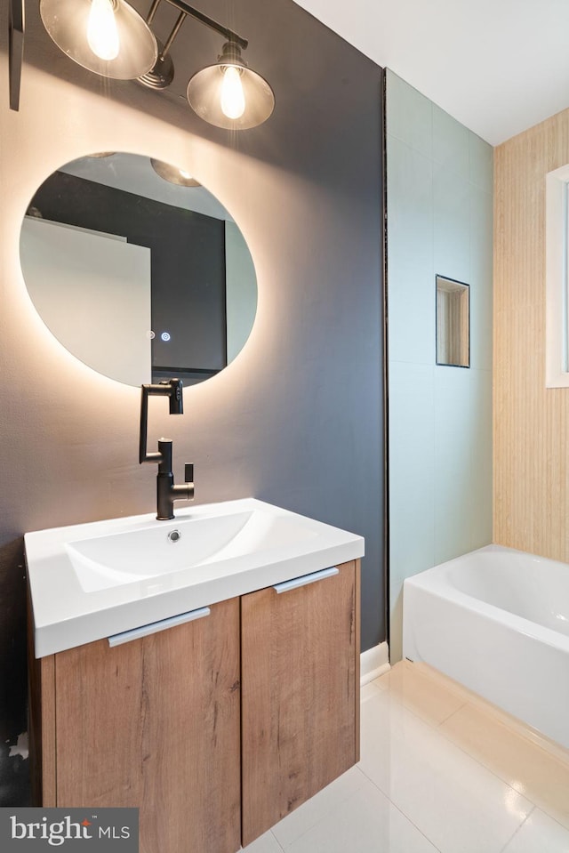 bathroom with tile patterned flooring, vanity, and a bathtub