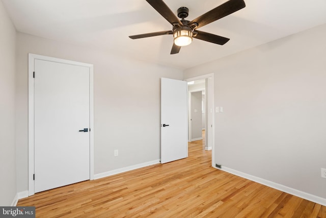 unfurnished bedroom with ceiling fan and light wood-type flooring