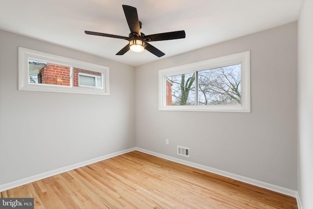 spare room featuring ceiling fan and light hardwood / wood-style flooring