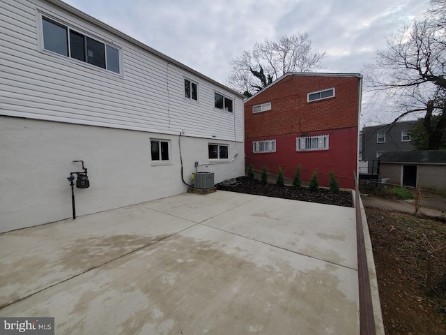 view of side of home featuring central AC and a patio