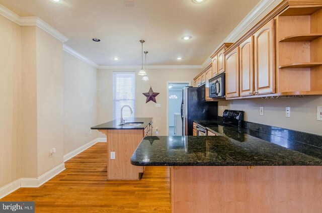 kitchen with sink, black electric range oven, dark stone counters, decorative light fixtures, and light wood-type flooring