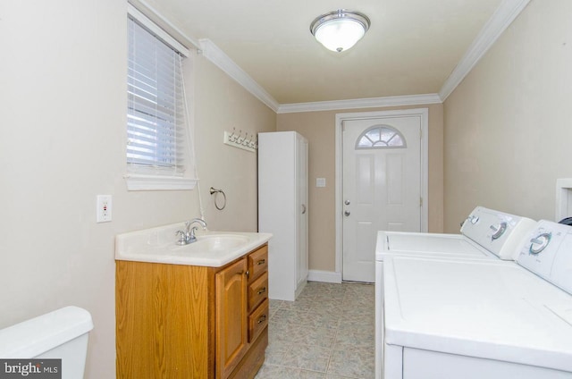 laundry room with independent washer and dryer, ornamental molding, and sink