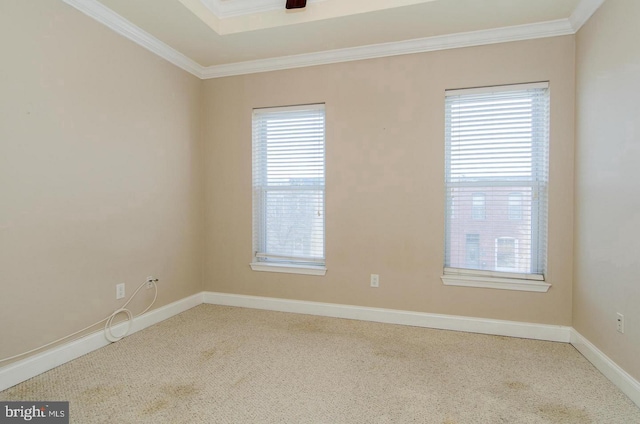 carpeted empty room with crown molding, ceiling fan, and a healthy amount of sunlight