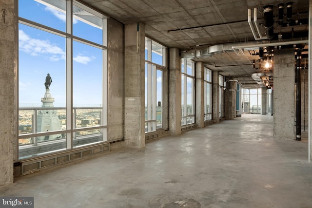 miscellaneous room with concrete floors and a wall of windows