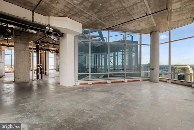 interior space featuring a wall of windows and concrete floors