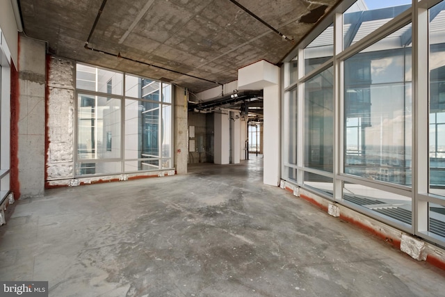 interior space featuring plenty of natural light and concrete flooring