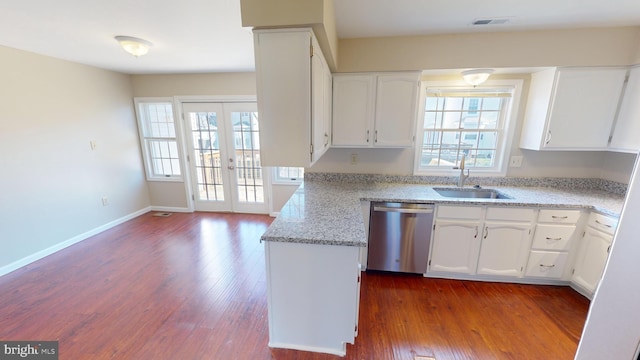 kitchen with french doors, light stone counters, stainless steel dishwasher, sink, and white cabinets