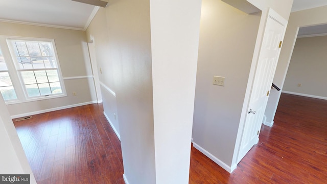 hall with crown molding and dark wood-type flooring