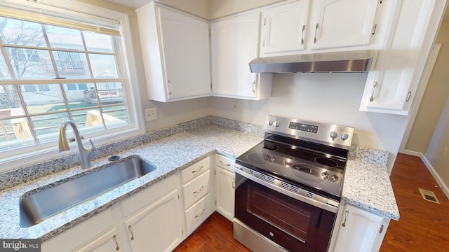 kitchen with light stone countertops, sink, dark hardwood / wood-style flooring, electric stove, and white cabinets