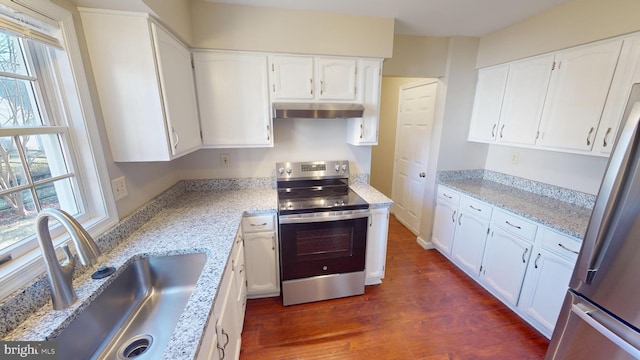 kitchen featuring light stone countertops, stainless steel appliances, sink, dark hardwood / wood-style floors, and white cabinetry