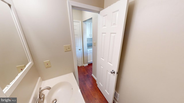 bathroom with hardwood / wood-style flooring and sink