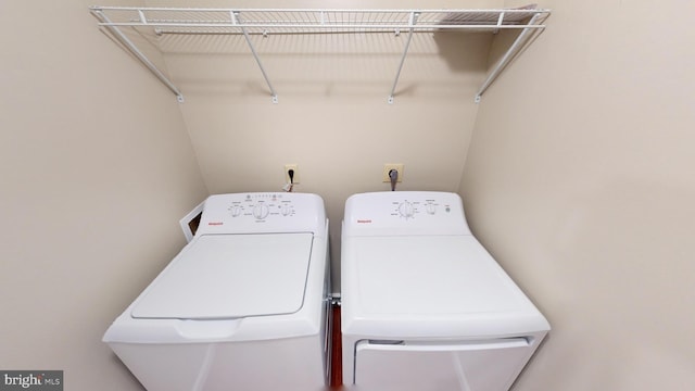 clothes washing area with washing machine and clothes dryer