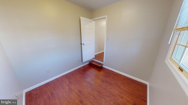 unfurnished room with dark hardwood / wood-style floors