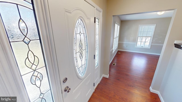 entryway with dark hardwood / wood-style floors