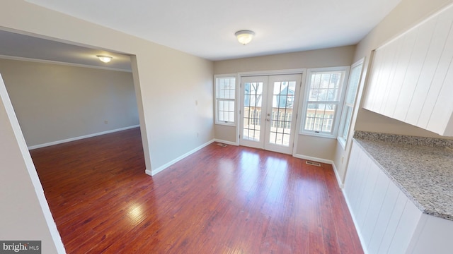 unfurnished room with dark wood-type flooring and french doors