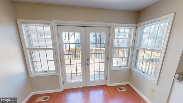 doorway to outside with french doors and light wood-type flooring