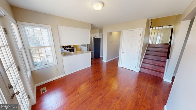 unfurnished living room featuring dark wood-type flooring