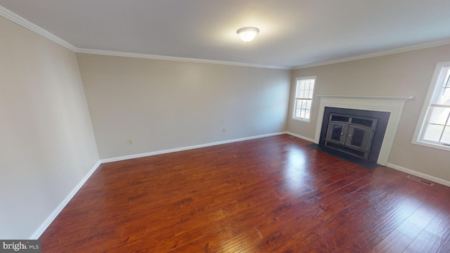 unfurnished living room featuring dark hardwood / wood-style floors and ornamental molding