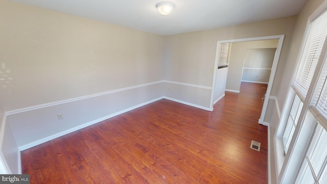 unfurnished room with dark hardwood / wood-style floors