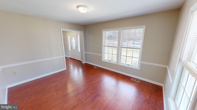 unfurnished room featuring dark hardwood / wood-style flooring