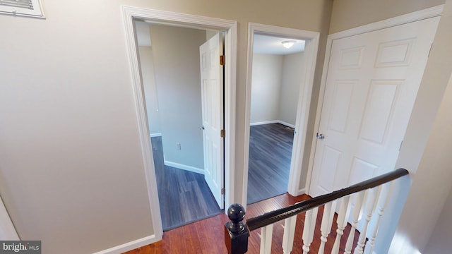 hallway featuring dark hardwood / wood-style flooring