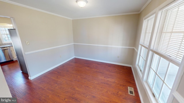 spare room with ornamental molding and dark wood-type flooring