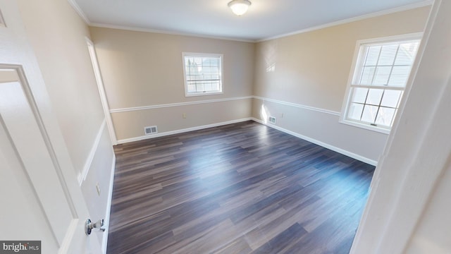 unfurnished room featuring plenty of natural light, dark hardwood / wood-style flooring, and ornamental molding