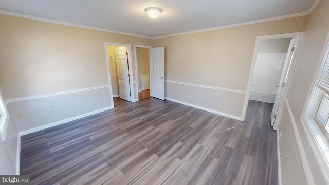 unfurnished bedroom featuring dark hardwood / wood-style flooring, connected bathroom, a closet, and ornamental molding