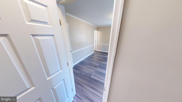 hall featuring crown molding and hardwood / wood-style floors