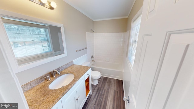 full bathroom featuring a wealth of natural light, toilet, vanity, and hardwood / wood-style flooring