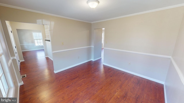 unfurnished room featuring crown molding and dark wood-type flooring