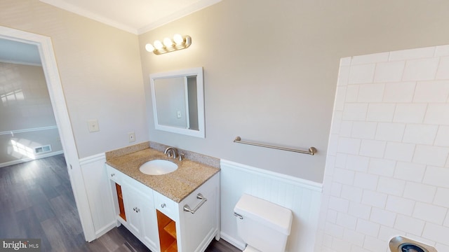 bathroom featuring wood-type flooring, vanity, toilet, and ornamental molding