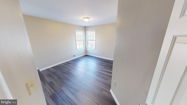 unfurnished room with dark hardwood / wood-style flooring