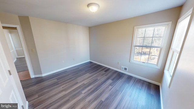 spare room featuring dark hardwood / wood-style flooring