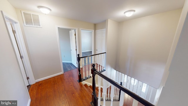 hall with hardwood / wood-style flooring