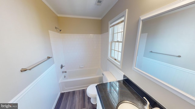 full bathroom featuring hardwood / wood-style floors, washtub / shower combination, sink, toilet, and ornamental molding