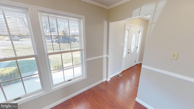 entryway featuring hardwood / wood-style floors and ornamental molding