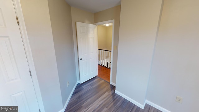 corridor with dark hardwood / wood-style floors