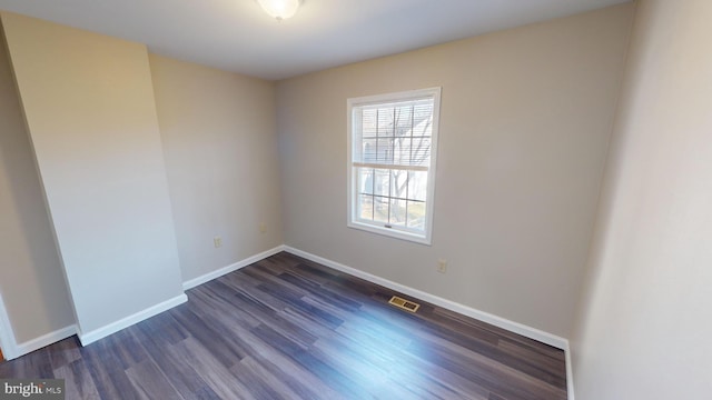 spare room with dark hardwood / wood-style floors