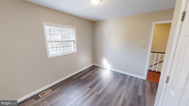 spare room with dark hardwood / wood-style flooring