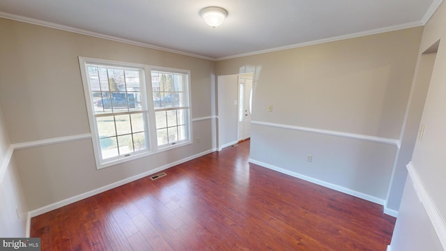 empty room with dark hardwood / wood-style floors and ornamental molding