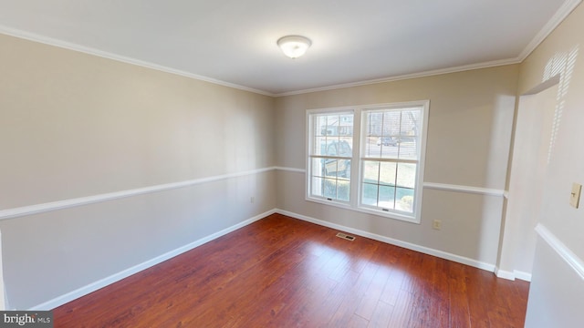 unfurnished room with dark hardwood / wood-style flooring and crown molding