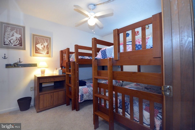 bedroom featuring light colored carpet and baseboards