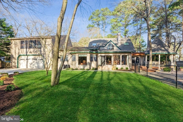 view of front facade with a garage and a front lawn