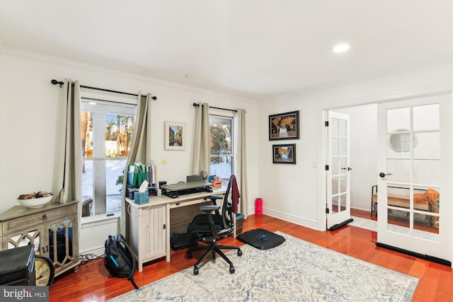 office with light wood-type flooring and crown molding